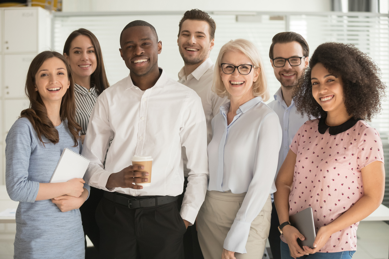 Motivated international multi-ethnic company members aged and young corporate team photographing posing for camera, successful staff portrait concept of growth in career leadership and racial equality