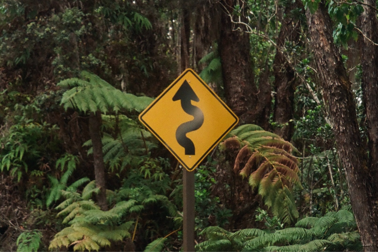 An image of a sign depicting a winding road ahead -- a metaphor for communications challenges leaders in the industry will face in the next five years. Image credit: Photo by Danyelle Lopez on Unsplash